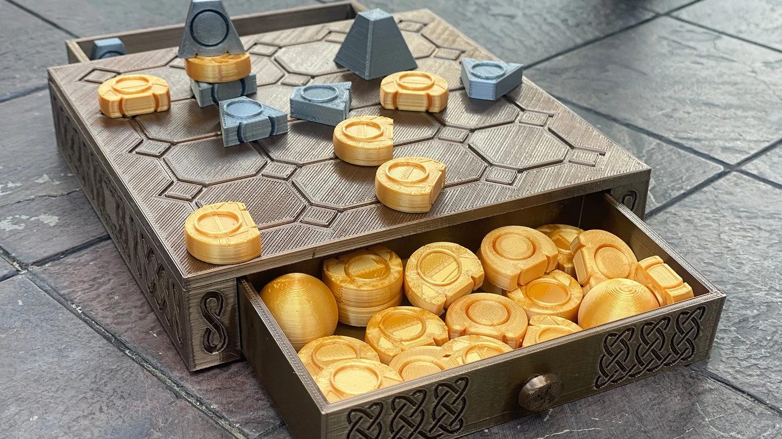 A 3D-printed strategy game with hexagonal tiles and tokens.